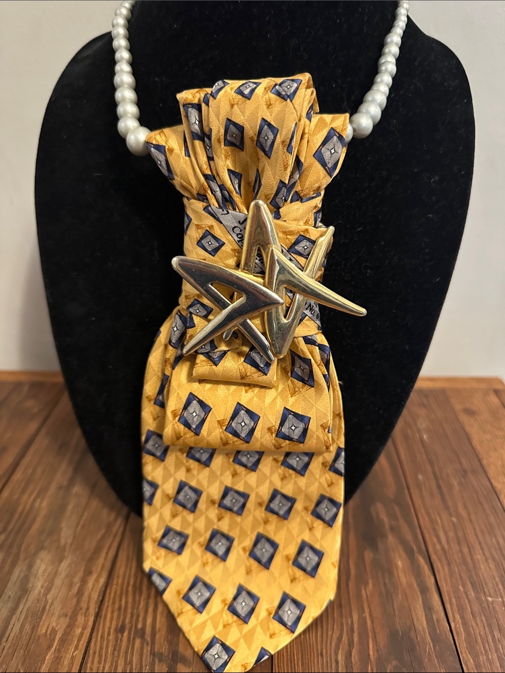 Gold and Navy Geometric Silk Tie with Bold Starburst Brooch .